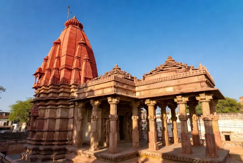 The weather-worn stone stairs descending beneath the street level into Atmateshwar Temple