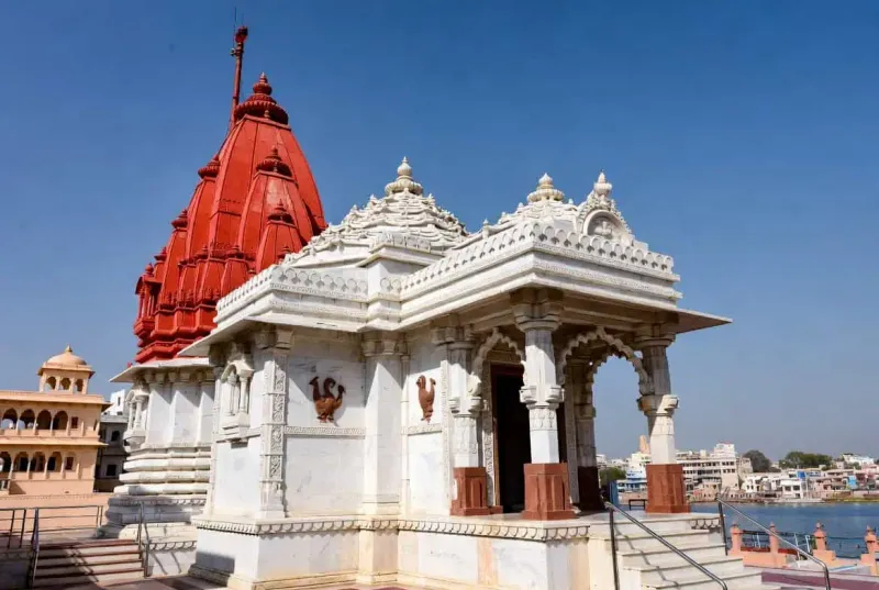 The bright red shikhara and blue-painted pillars of Jagatpita Brahma Temple in Pushkar